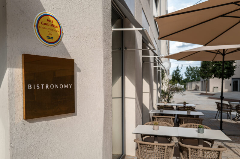 Terrace and entrance to the Bistronomy restaurant - next to the entrance is an award from Gault&Millau
